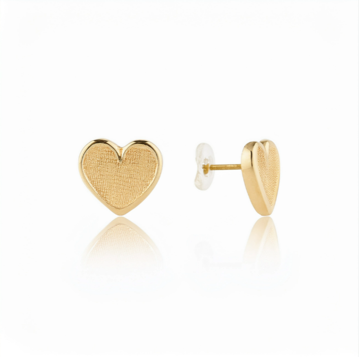 A pair of 14k gold heart shaped flat back earrings, designed for comfortable wear in helix and lobe piercings.