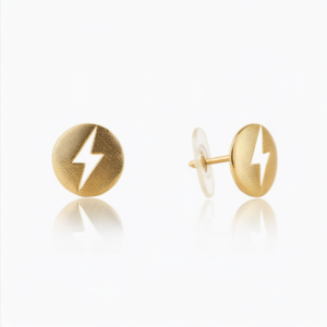 A pair of 14k gold flat back earrings featuring a polished gold disc with a lightning bolt engraving, ideal for helix and cartilage piercings.